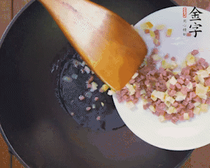 油溫3成熱時(shí)，下火腿丁、筍丁炒出香味，放豌豆粒翻炒均勻2分鐘。